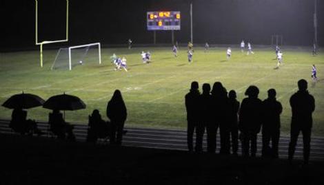Girls soccer fans watch the action during the nightcap. /Stefan Hard, TA